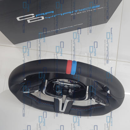 Steering wheel with 'Car Dynamics' branding on a branded background