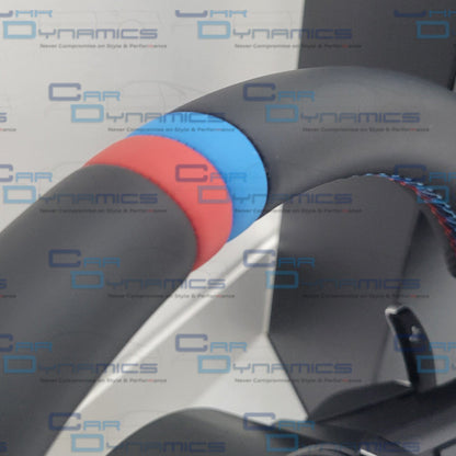 Close-up of a car bmw steering wheel with red, blue, and black accents on a white background with 'Car Dynamics' branding.