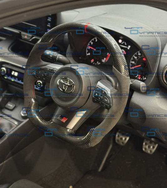 Car interior with bespoke toyota gr yaris carbon fibre flat bottom steering wheel by car dynamics
